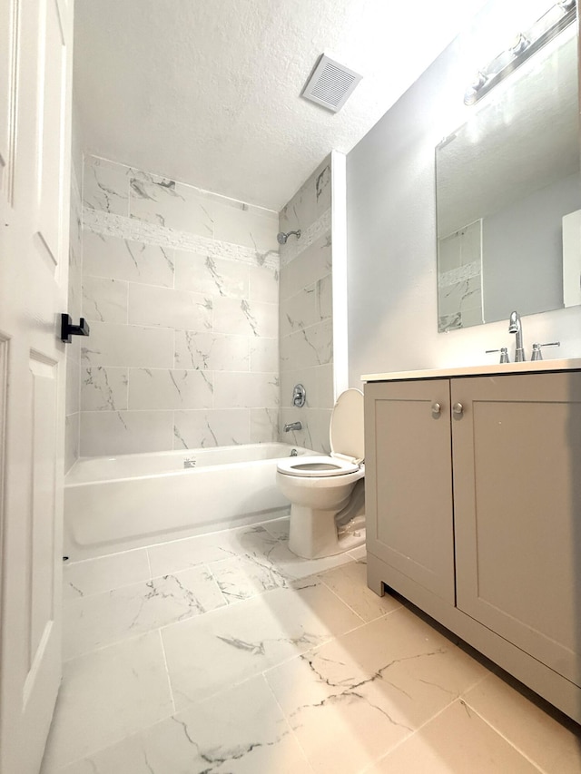673 SW Granadeer St, Port Saint Lucie, FL 34983 - full bathroom featuring a textured ceiling, toilet, marble finish floor, visible vents, and washtub / shower combination