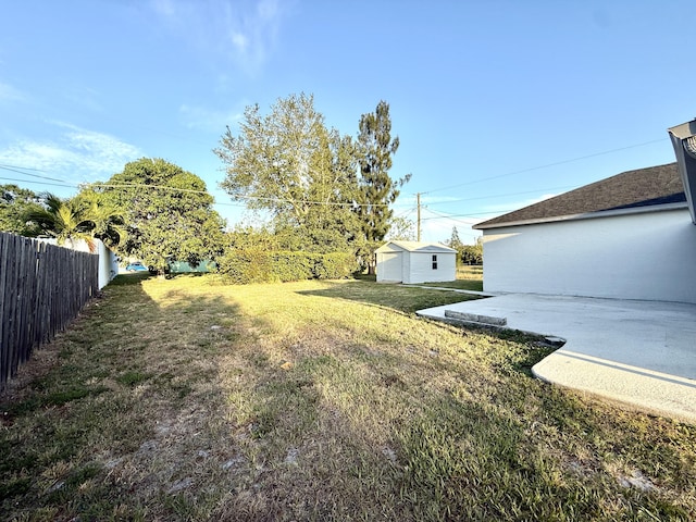 673 SW Granadeer St, Port Saint Lucie, FL 34983 - view of yard featuring an outdoor structure, fence, and a patio