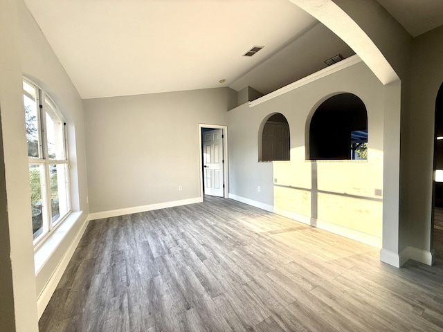 673 SW Granadeer St, Port Saint Lucie, FL 34983 - unfurnished room with vaulted ceiling, baseboards, visible vents, and wood finished floors