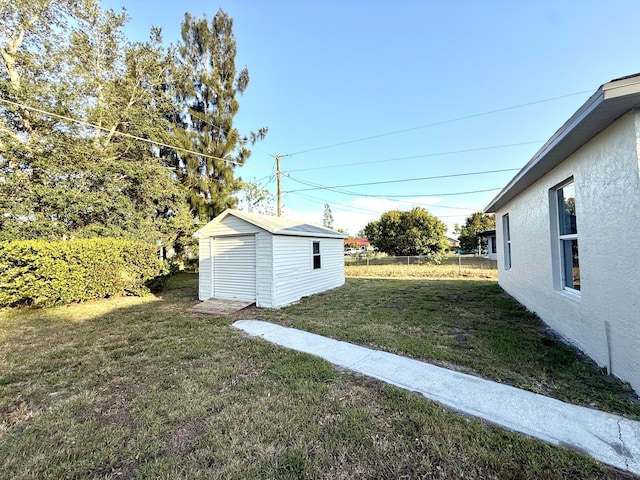 673 SW Granadeer St, Port Saint Lucie, FL 34983 - view of yard with an outbuilding, fence, and a shed