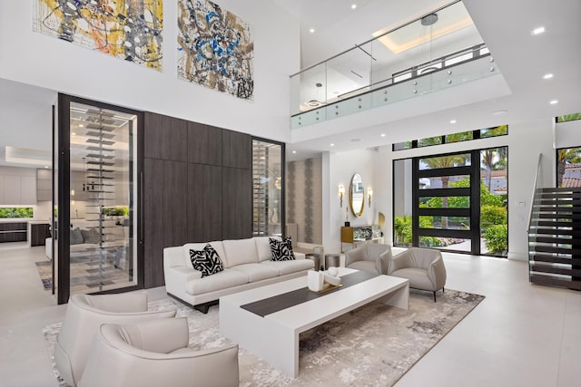 common area with a high ceiling, recessed lighting, and stairway