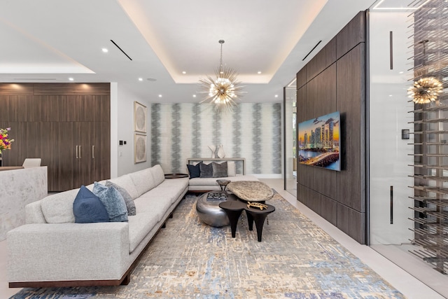living room with a raised ceiling, a chandelier, and recessed lighting