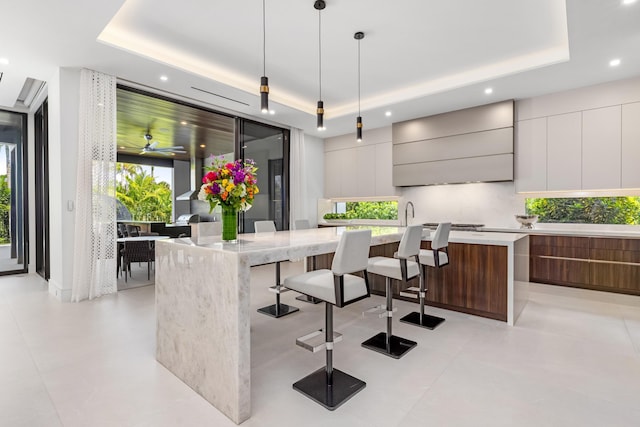 bar featuring a raised ceiling, decorative light fixtures, recessed lighting, healthy amount of natural light, and custom range hood