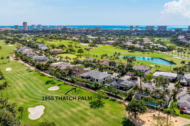 view of urban area featuring a nearby body of water, a golf club, and nearby suburban area