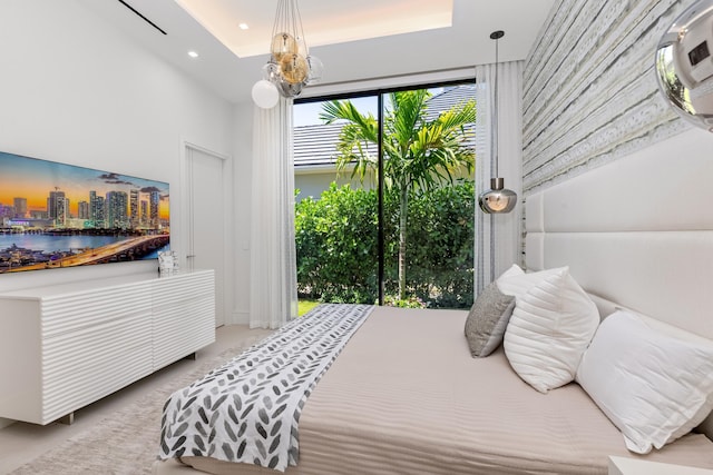 bedroom with recessed lighting, a city view, carpet, and a chandelier