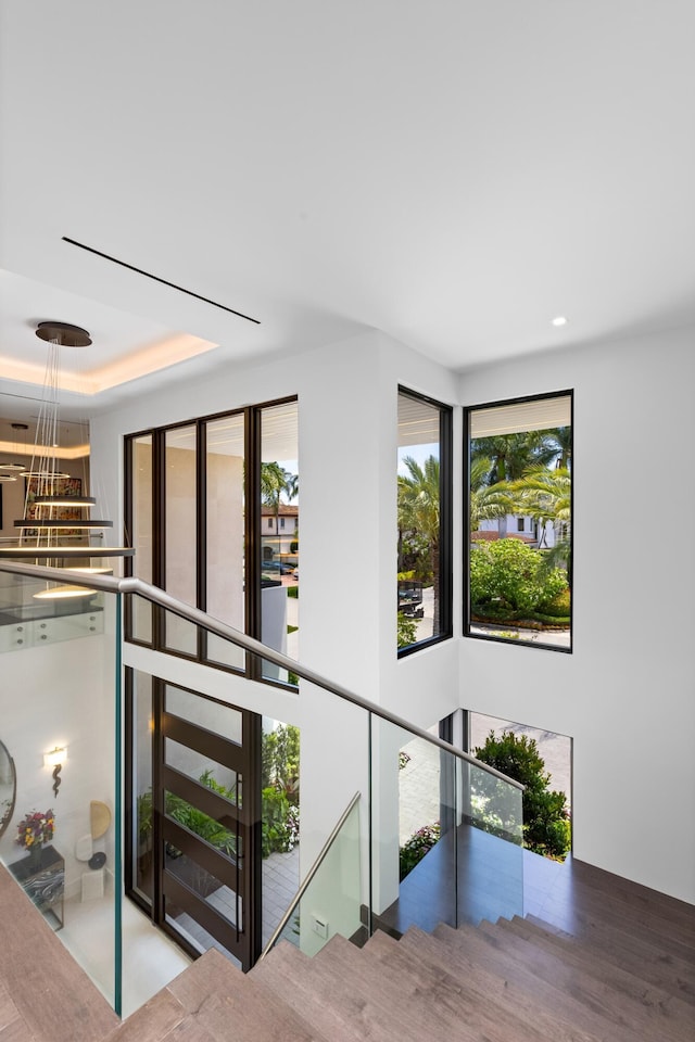 hallway featuring an upstairs landing and recessed lighting