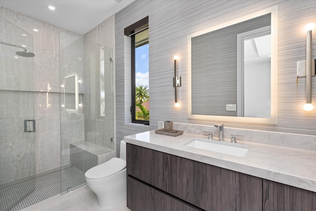 full bath featuring tile walls, toilet, a stall shower, and vanity
