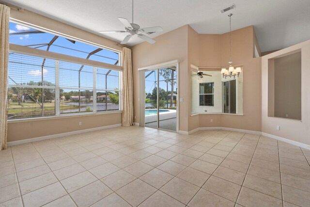 empty room with light tile patterned flooring, baseboards, and visible vents