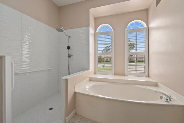 full bathroom featuring tile patterned flooring, tiled shower, and a bath