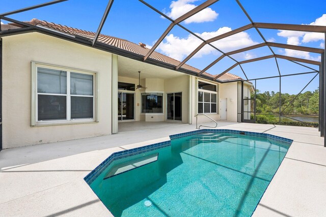 outdoor pool featuring a lanai, a patio, and ceiling fan