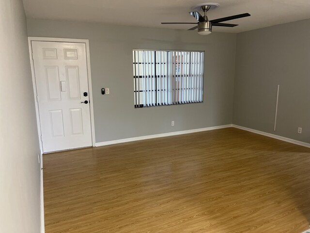 4237 Oak Terrace Dr, Greenacres, FL 33463 - unfurnished room with baseboards, ceiling fan, and wood finished floors