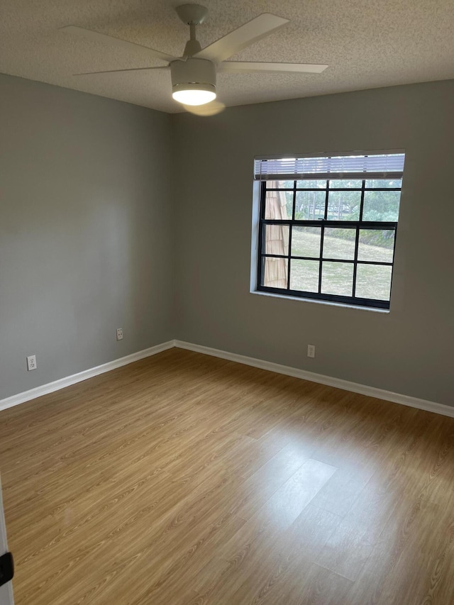 4237 Oak Terrace Dr, Greenacres, FL 33463 - empty room with baseboards, ceiling fan, and wood finished floors