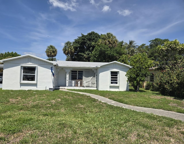 431 Virginia Dr, Lake Worth Beach, FL 33461 - single story home featuring a porch, a front lawn, and stucco siding