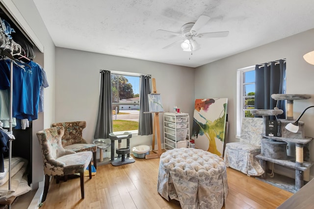 431 Virginia Dr, Lake Worth Beach, FL 33461 - living area featuring plenty of natural light, ceiling fan, wood finished floors, and a textured ceiling