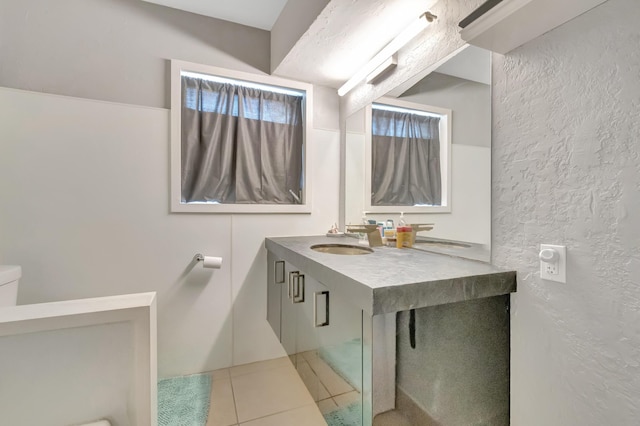 431 Virginia Dr, Lake Worth Beach, FL 33461 - bathroom featuring toilet, tile patterned flooring, a textured wall, and vanity