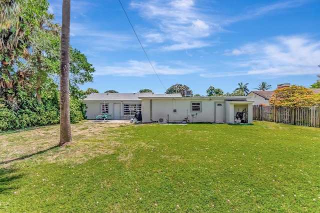 431 Virginia Dr, Lake Worth Beach, FL 33461 - rear view of property featuring stucco siding and a patio