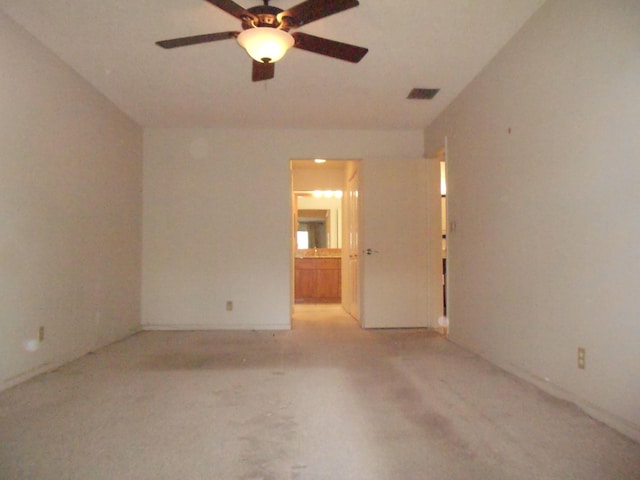 spare room with a ceiling fan, baseboards, and visible vents