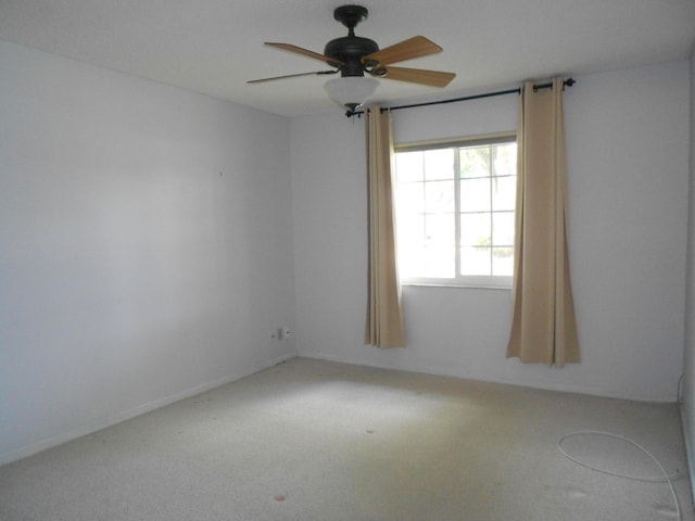 spare room featuring carpet flooring and ceiling fan