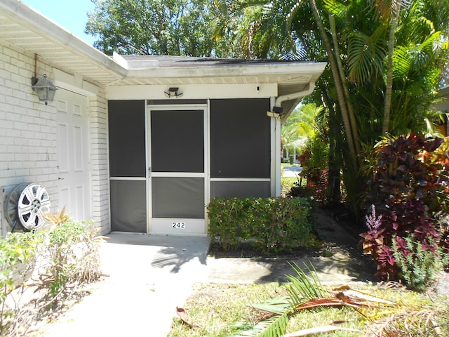 doorway to property with brick siding