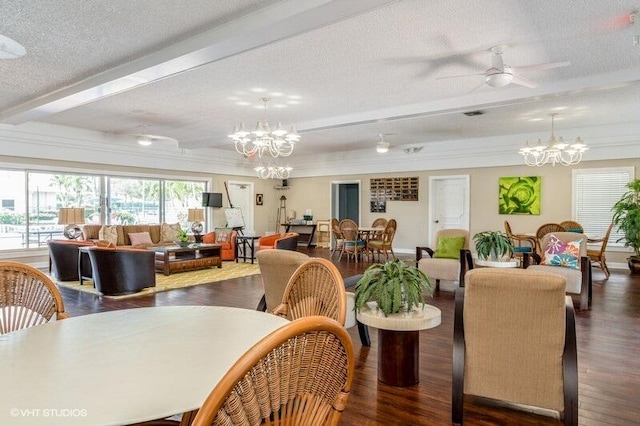 dining area with a textured ceiling, ceiling fan with notable chandelier, wood finished floors, and beam ceiling
