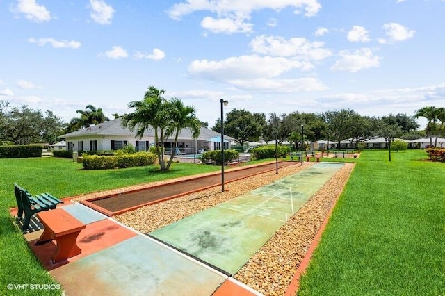 view of community featuring a yard and shuffleboard