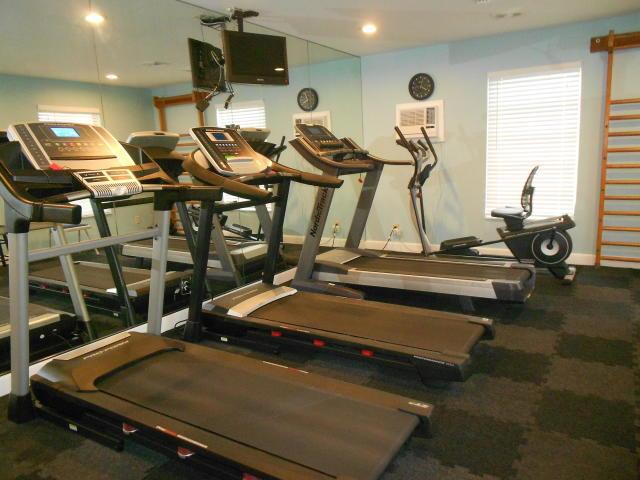 gym featuring carpet flooring and baseboards