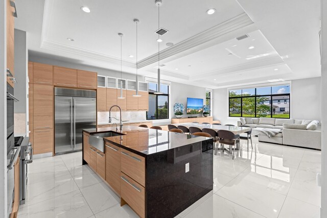 10715 Estuary Dr, Parkland, FL 33076 - kitchen with a sink, modern cabinets, a tray ceiling, and built in fridge
