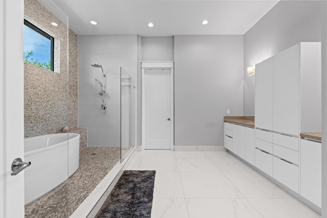 10715 Estuary Dr, Parkland, FL 33076 - full bath with vanity, marble finish floor, recessed lighting, a freestanding bath, and a stall shower