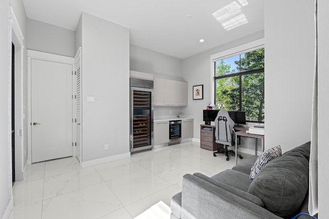 10715 Estuary Dr, Parkland, FL 33076 - home office with baseboards, recessed lighting, marble finish floor, and wine cooler