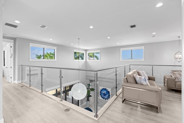 10715 Estuary Dr, Parkland, FL 33076 - hallway featuring an upstairs landing, wood finished floors, and visible vents