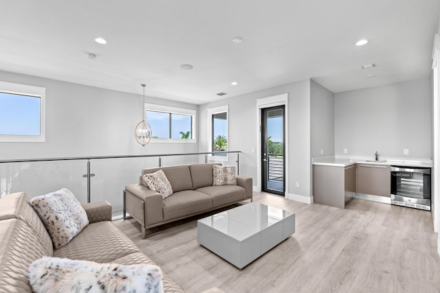 10715 Estuary Dr, Parkland, FL 33076 - living area featuring beverage cooler, plenty of natural light, and light wood-style flooring