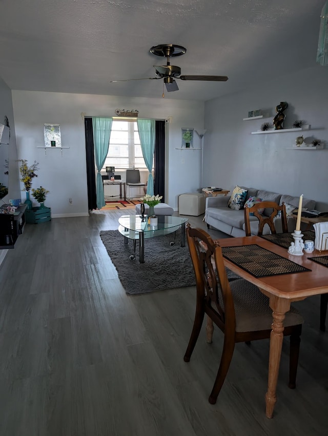 dining space featuring a ceiling fan, baseboards, and wood finished floors