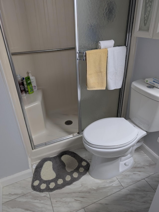 full bath with toilet, baseboards, a shower stall, and marble finish floor
