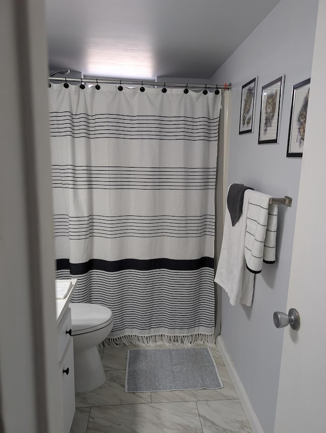 full bathroom featuring vanity, marble finish floor, toilet, and a shower with curtain