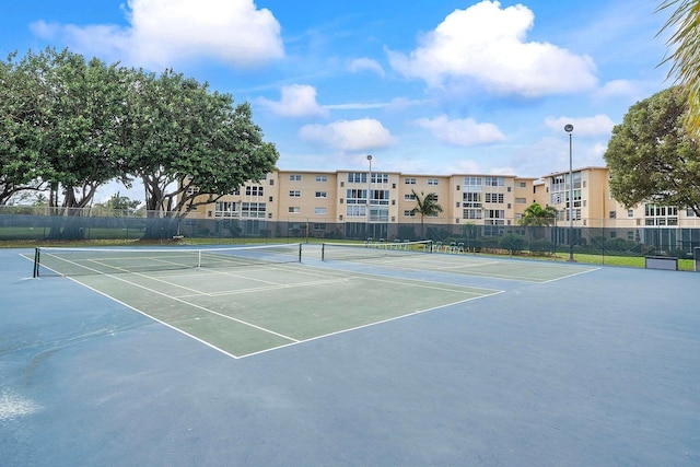 view of tennis court featuring fence