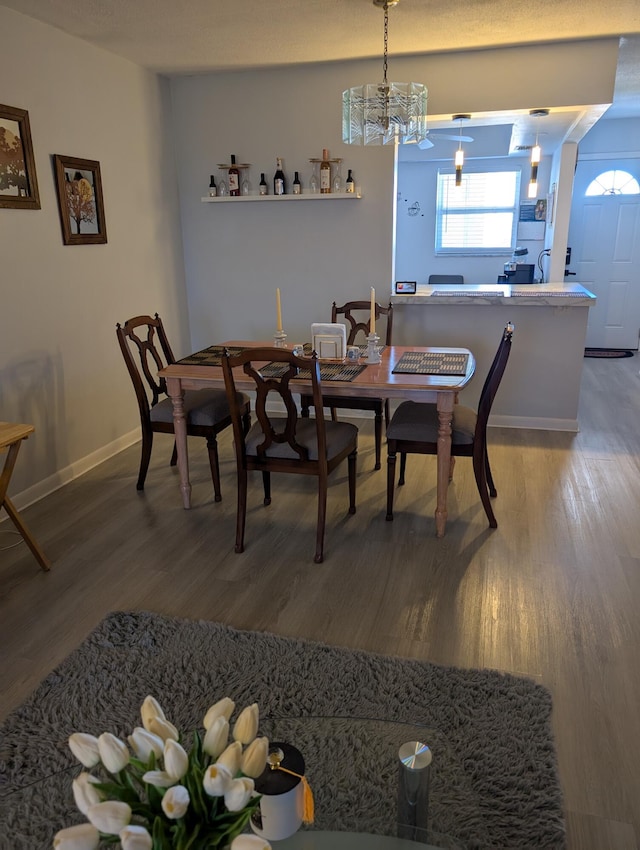 dining area featuring baseboards and wood finished floors