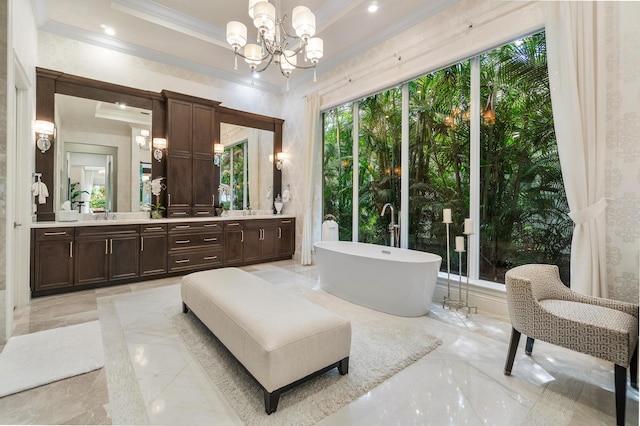 bathroom featuring double vanity, crown molding, a freestanding bath, marble finish floor, and an inviting chandelier