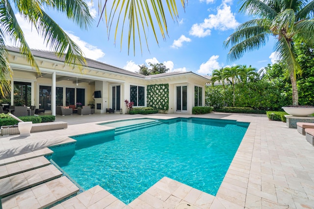 pool with a patio and an outdoor living space