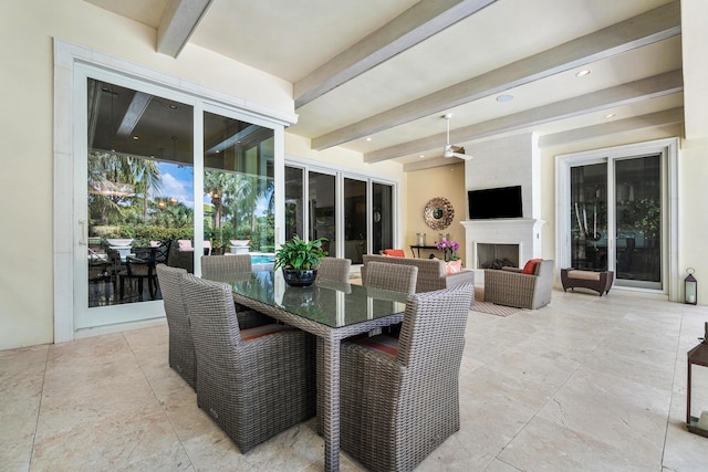 view of patio featuring an outdoor living space with a fireplace, ceiling fan, and outdoor dining space