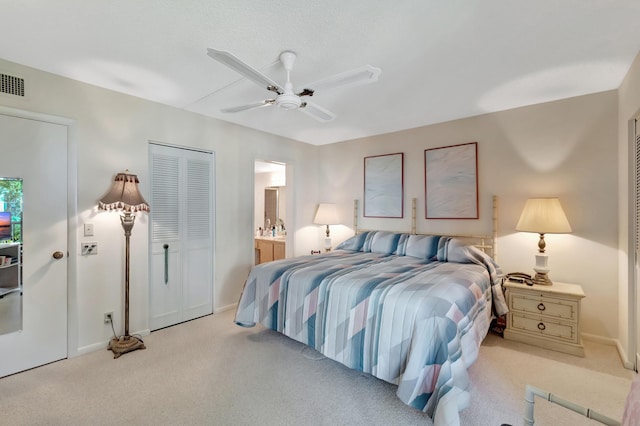 6585 Kensington Ln Unit 307, Delray Beach, FL 33446 - bedroom with light colored carpet, ceiling fan, ensuite bathroom, and baseboards