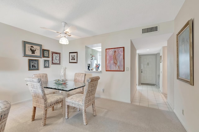 6585 Kensington Ln Unit 307, Delray Beach, FL 33446 - dining space featuring light carpet, a ceiling fan, a textured ceiling, light tile patterned floors, and baseboards