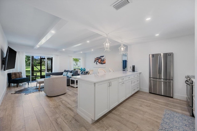 13334 Polo Club Rd Unit 234/235, Wellington, FL 33414 - kitchen featuring visible vents, light wood finished floors, a peninsula, and stainless steel appliances