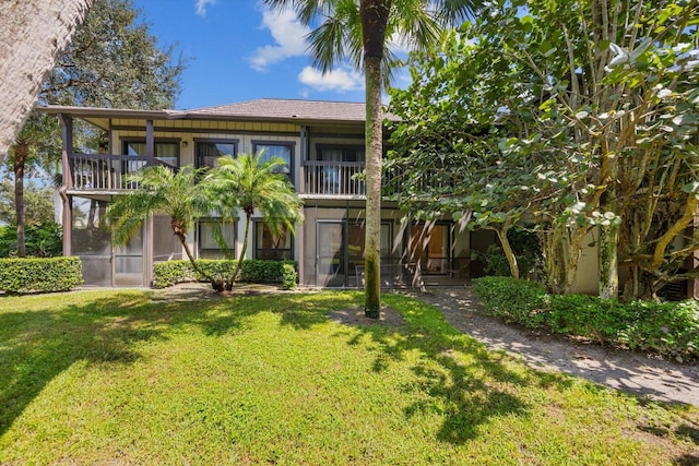 13334 Polo Club Rd Unit 234/235, Wellington, FL 33414 - view of front of home with a balcony, a sunroom, and a front yard
