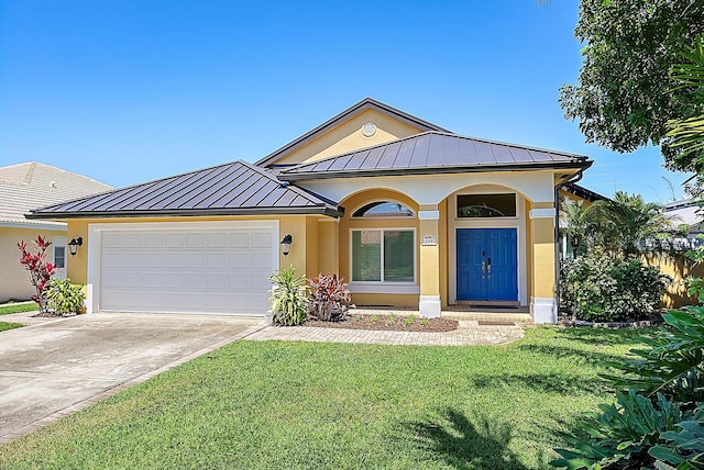 500 N Cypress Dr, Tequesta, FL 33469 - ranch-style home with a standing seam roof, driveway, an attached garage, and metal roof