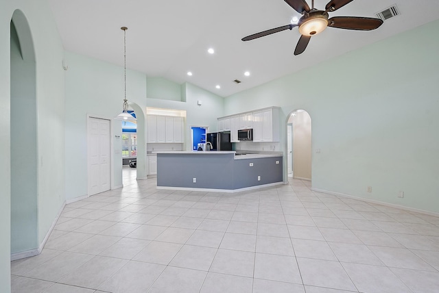 500 N Cypress Dr, Tequesta, FL 33469 - kitchen featuring stainless steel microwave, freestanding refrigerator, open floor plan, light countertops, and white cabinetry