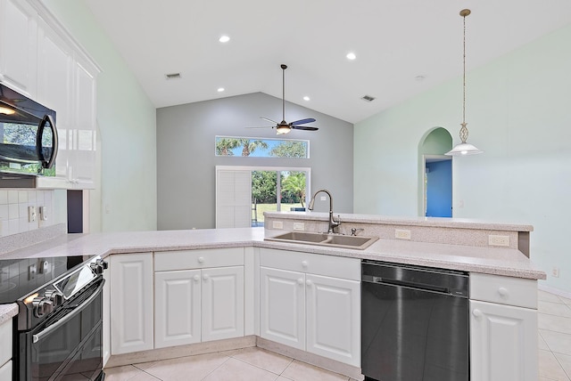 500 N Cypress Dr, Tequesta, FL 33469 - kitchen featuring black appliances, a sink, ceiling fan, light tile patterned flooring, and vaulted ceiling