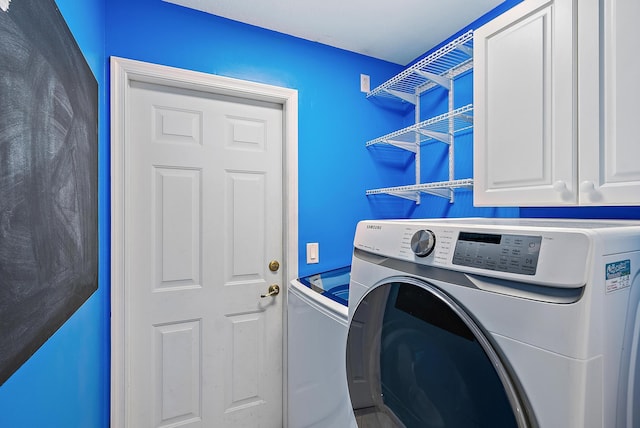 500 N Cypress Dr, Tequesta, FL 33469 - washroom featuring separate washer and dryer and cabinet space