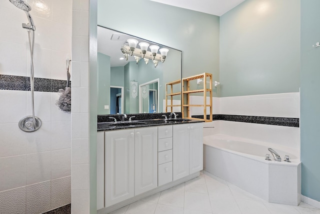 500 N Cypress Dr, Tequesta, FL 33469 - bathroom featuring a garden tub, tiled shower, tile patterned flooring, and double vanity