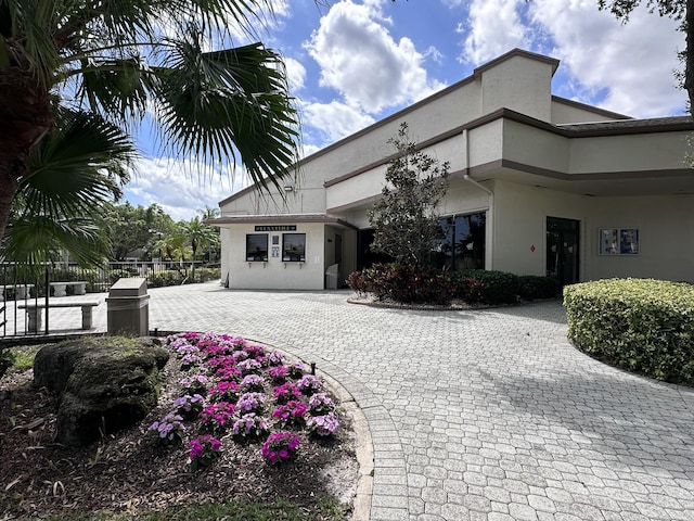 3206 Carambola Cir S, Coconut Creek, FL 33066 - view of building exterior with fence, a garage, and decorative driveway