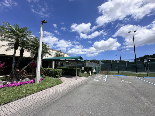 3206 Carambola Cir S, Coconut Creek, FL 33066 - uncovered parking lot featuring fence